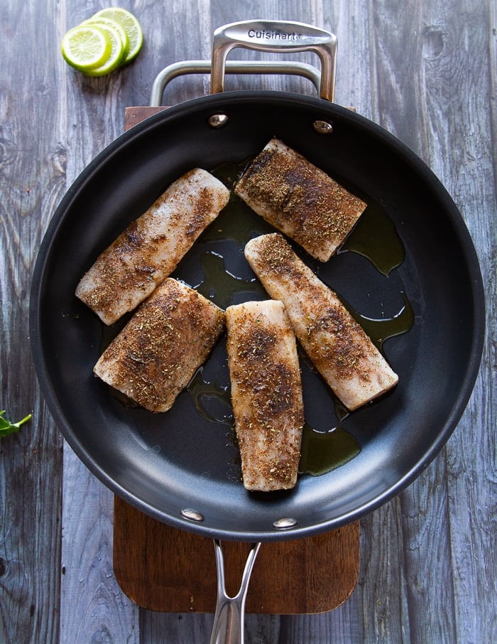 mahi mahi fish in a skillet cooking