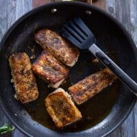 Perfectly cooked mahi mahi fish in a skillet, all crispy and browned up