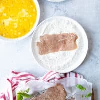 veal scallopini cutlet in the flour plate to be coated