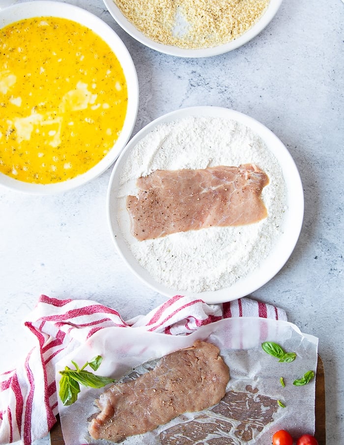 veal scallopini cutlet in the flour plate to be coated