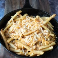 shredded cheese is added over the fries