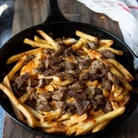 the pan is broiled and the cheese has melted over the fries and the meat has a crust