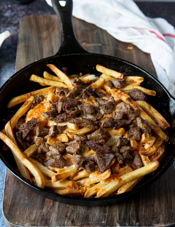 the pan is broiled and the cheese has melted over the fries and the meat has a crust 