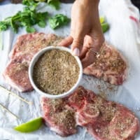 A hand showing a close up of the seasoning mix for carne asada recipe