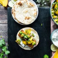 Salmon loaded over the sour cream on the tortilla and then avocado salsa