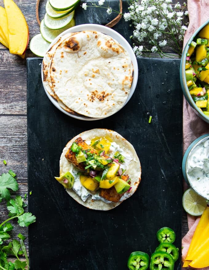 Salmon loaded over the sour cream on the tortilla and then avocado salsa