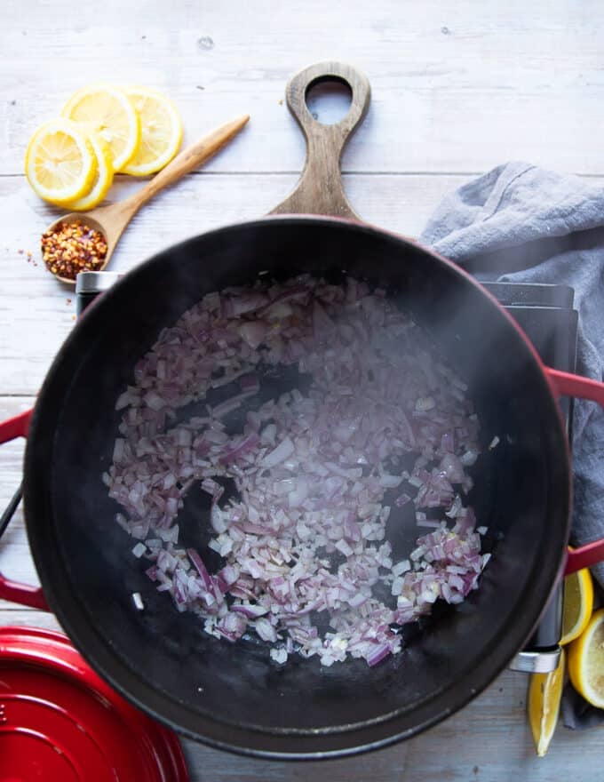 Onions sauteeing in a pan to make lamb stew