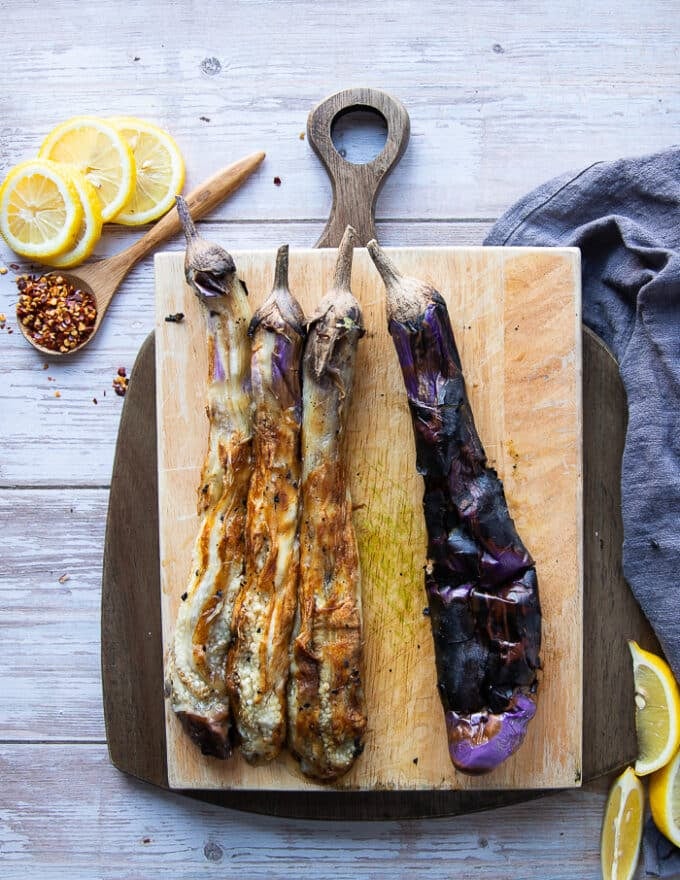 Peeling the charred skin of the eggplant leaving in the soft cooked and smokey eggplant