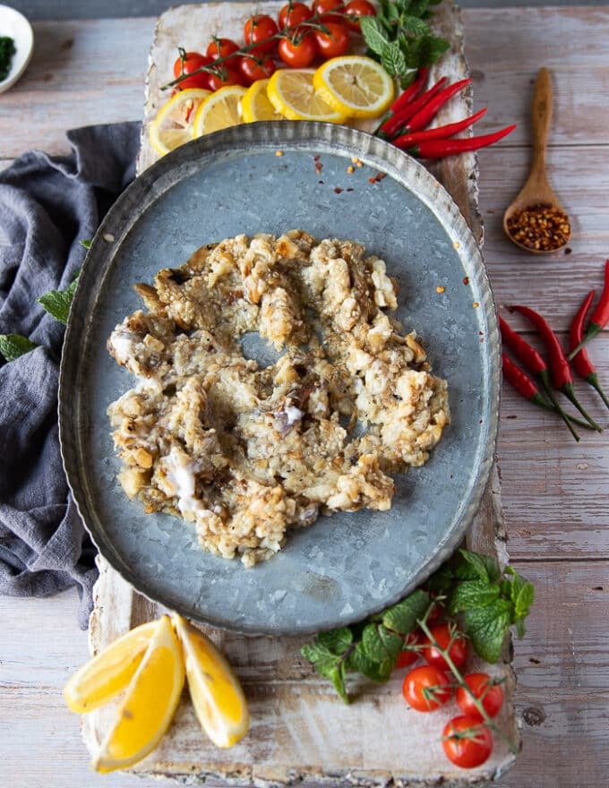 The chopped eggplant is layered at the bottom of a dish to serve Ali Nazik lamb stew