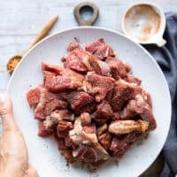 The Lamb tossed with spices in a bowl