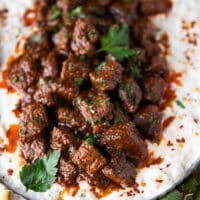 Close up of the chunks of lamb stew served over the eggplant yogurt mix. The lamb chunks are perfectly cooked