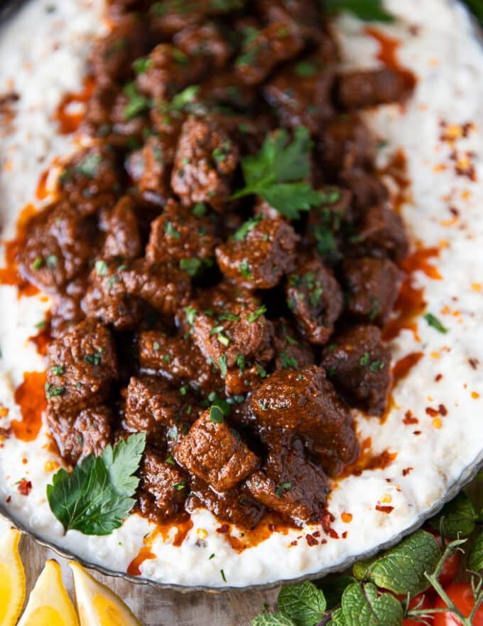 Close up of the chunks of lamb stew served over the eggplant yogurt mix. The lamb chunks are perfectly cooked