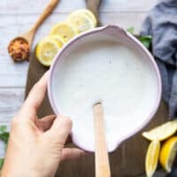 The yogurt sauce ready in a bowl by mixing the yogurt, lemon and salt