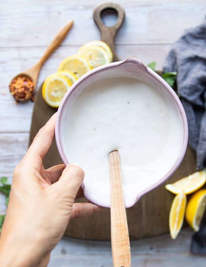 The yogurt sauce ready in a bowl by mixing the yogurt, lemon and salt