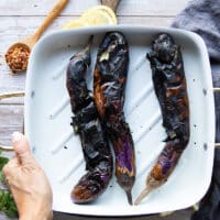 Fully charred eggplants on a plate