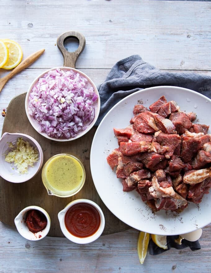 Stew ingredients including turkish pepper paste, tomato sauce, garlic, stock and onions