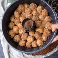 Fully arranged cinnamon roll monkey bread bundt pan ready to bake