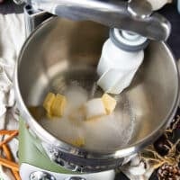 the butter and sugar are being creamed first in a stand mixer