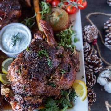 close up of one roast leg of lamb out of the oven golden brown and perfectly cooked