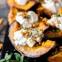 close up of one wedge of the sweet roasted acorn squash showing the golden caramelized squash