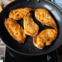 perfectly golden brown cicken breasts pan seared on each side for the chicken scallopini recipe