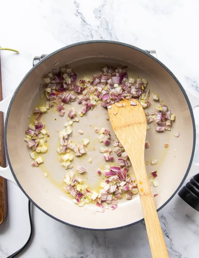 Onions sauté in a skillet with olive oil