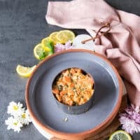 The marinated salmon mixture is placed right on top of the avocado and pressed down