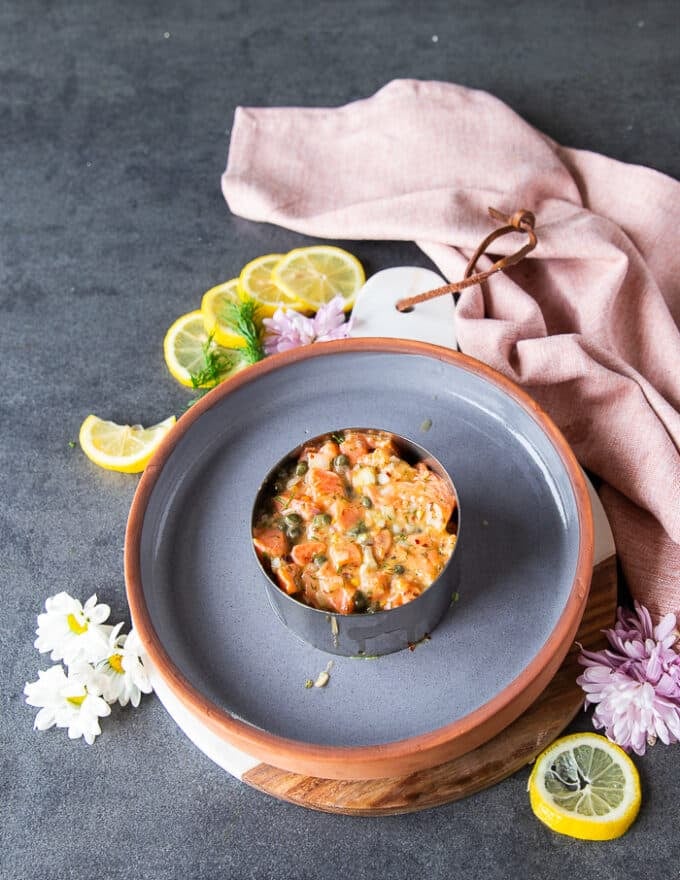 The marinated salmon mixture is placed right on top of the avocado and pressed down