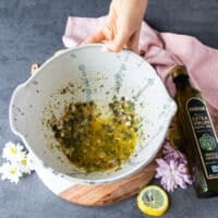 the marinade or flavoring ingredients for the salmon tartare is mixed into a large bowl .