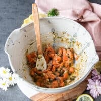 The Salmon cubes are added into the bowl of the marinade and tossed well