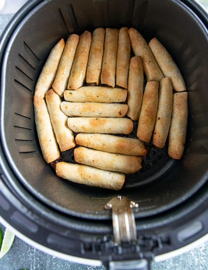 Golden and crisp taquitos ready in the air fryer basket