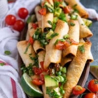 close up of air fryer taquitos in a plate showing how crisp the texture is