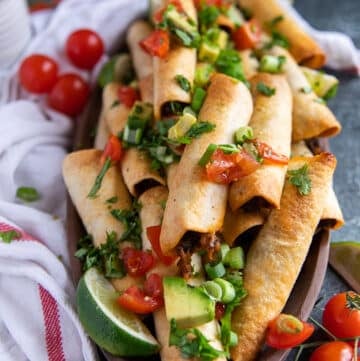 close up of air fryer taquitos in a plate showing how crisp the texture is