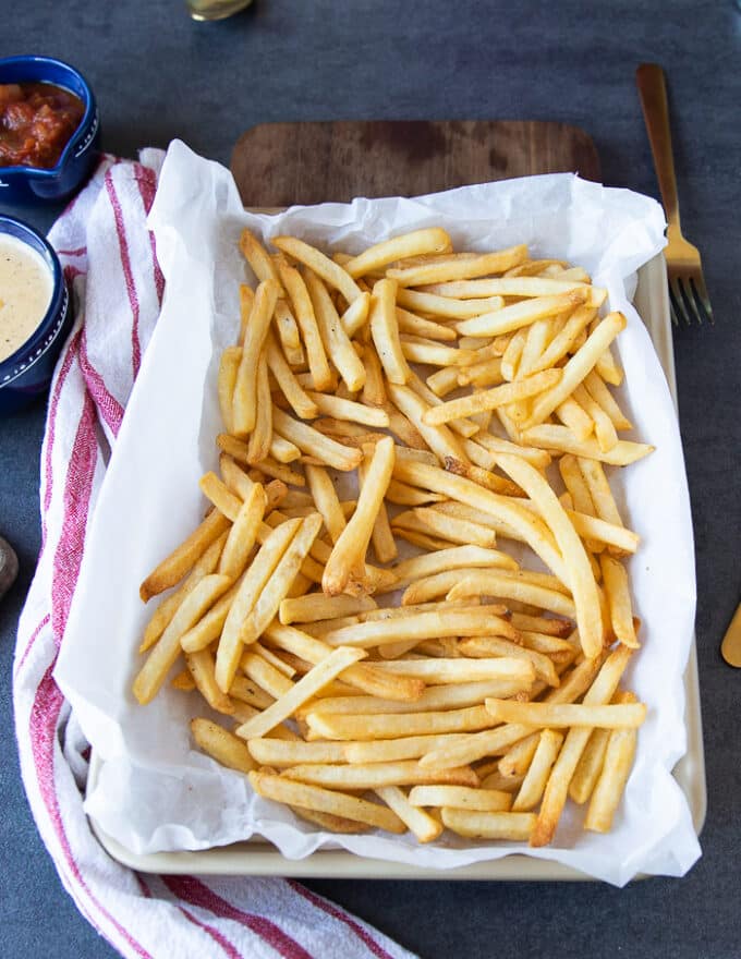 Cooked french fries spread on a serving plate