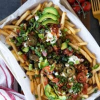 Remaining toppings added on-top of the cheese and beef beans over the fries