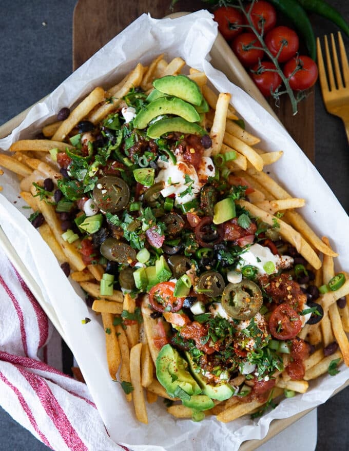 Remaining toppings added on-top of the cheese and beef beans over the fries