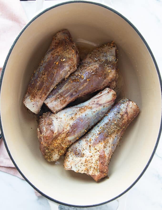 Lamb shanks in a heavy duty dutch oven pan for searing 
