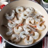 shrimp tossed in flour and added to a sesame oil skillet to sear