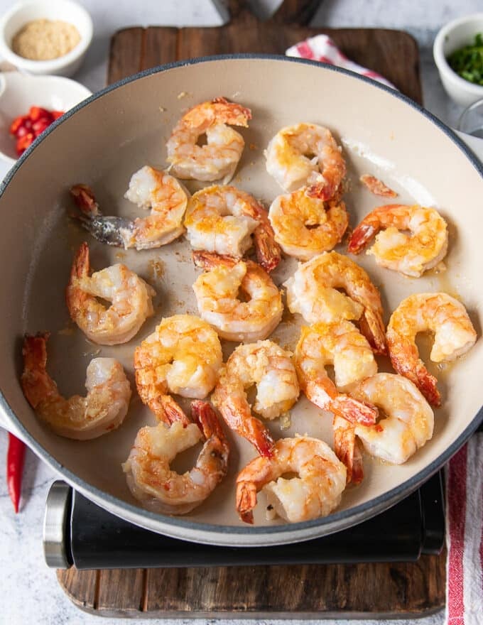 golden shrimp cooked in the pan and flipped over