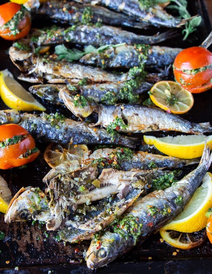 A cut open cooked sardine showing the flesh inside and how well cooked it is