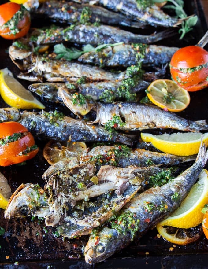 A cut open cooked sardine showing the flesh inside and how well cooked it is