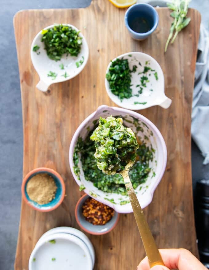 Ingredients mixed in a bowl to flavor the sardines which include garlic, herbs, olive oil and lemon and seasoning