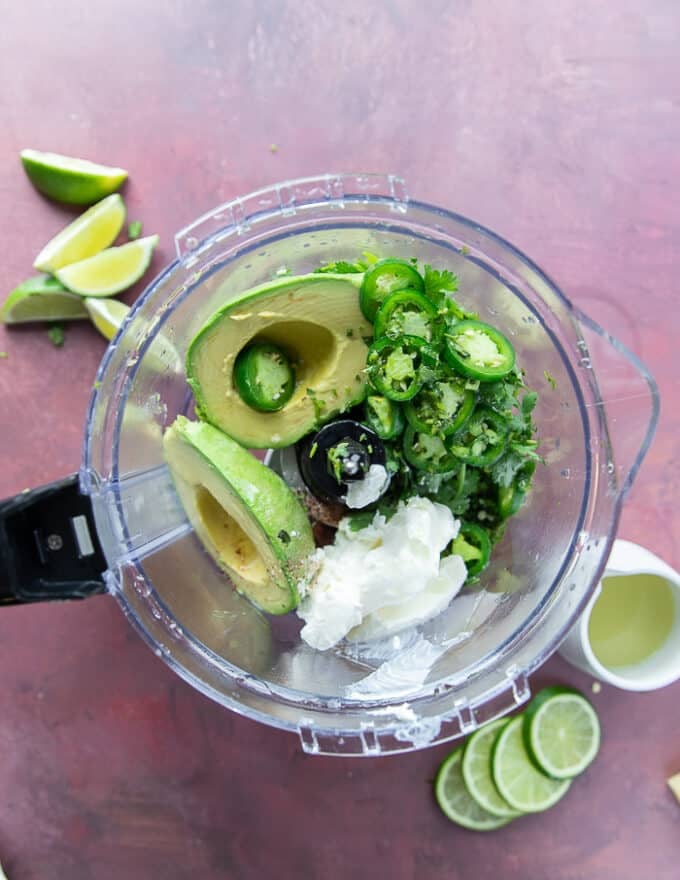 Avocado crema ingredients in a food processor 