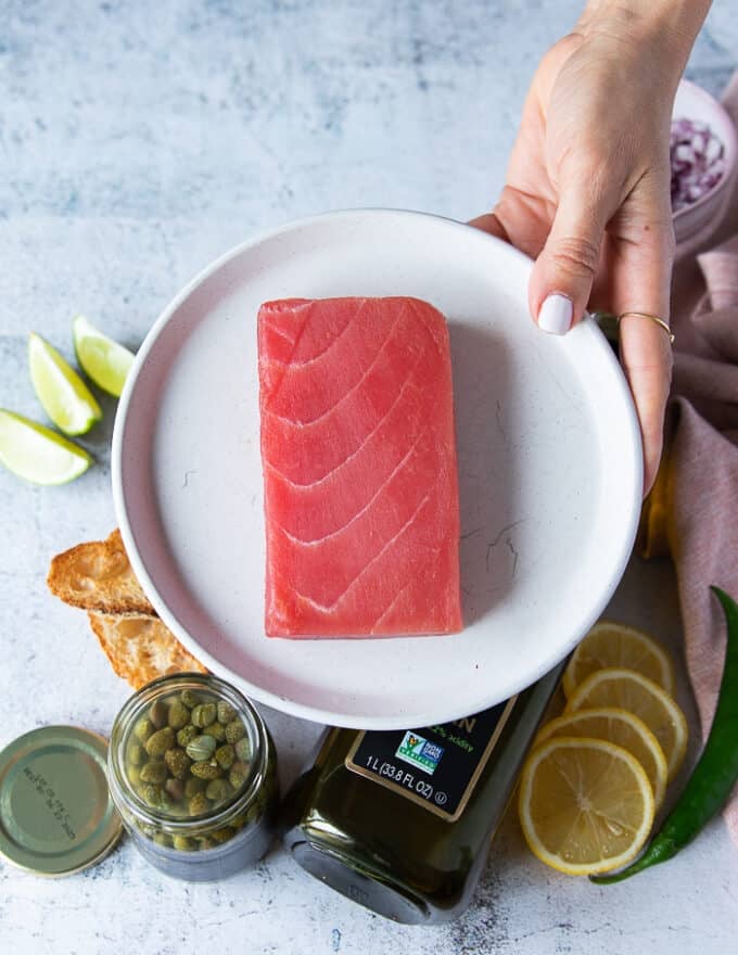 A block of fresh Saku tuna on a plate to make carpaccio