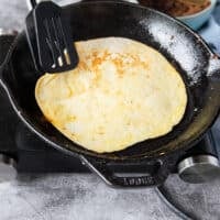 Flipped tortilla ready to start assembling the birria quesadillas