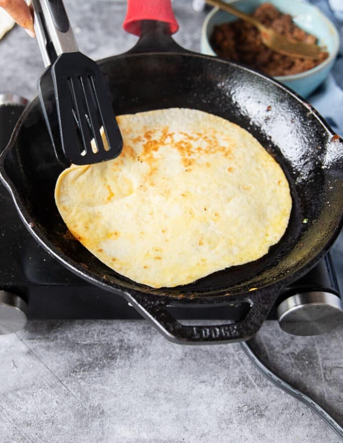 Flipped tortilla ready to start assembling the birria quesadillas 