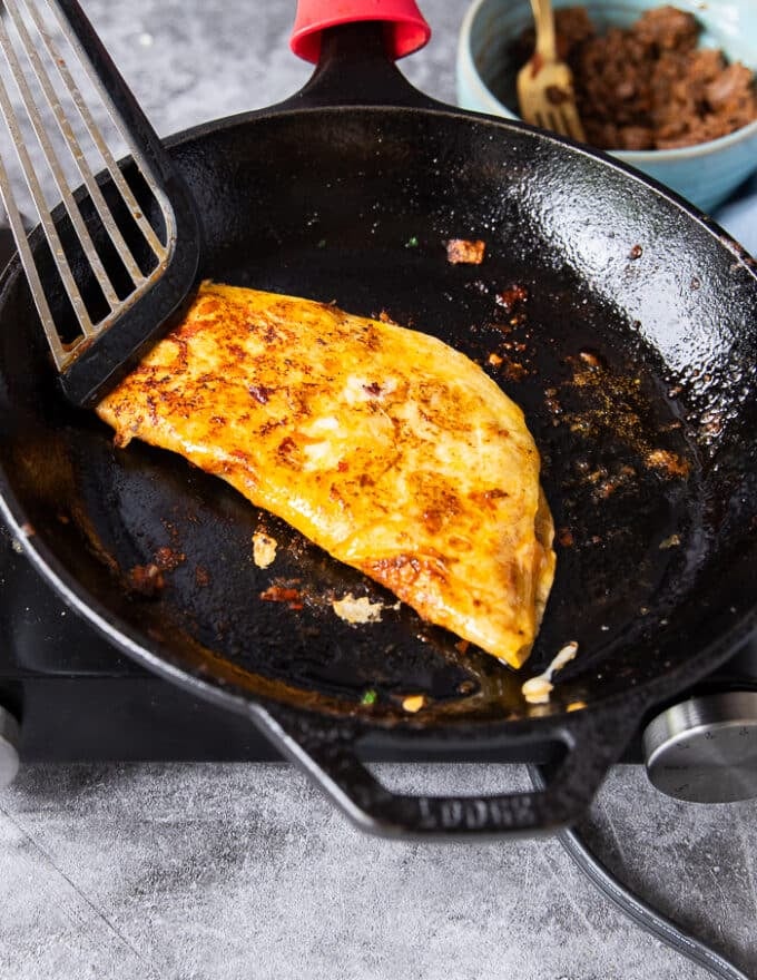 Tortillas is now folded in half to look like a quessadilla and then flipped to have a nice golden color on both sides 