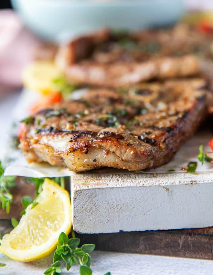 Side view of the lamb steaks showing the thickness, and grill marks on the steak