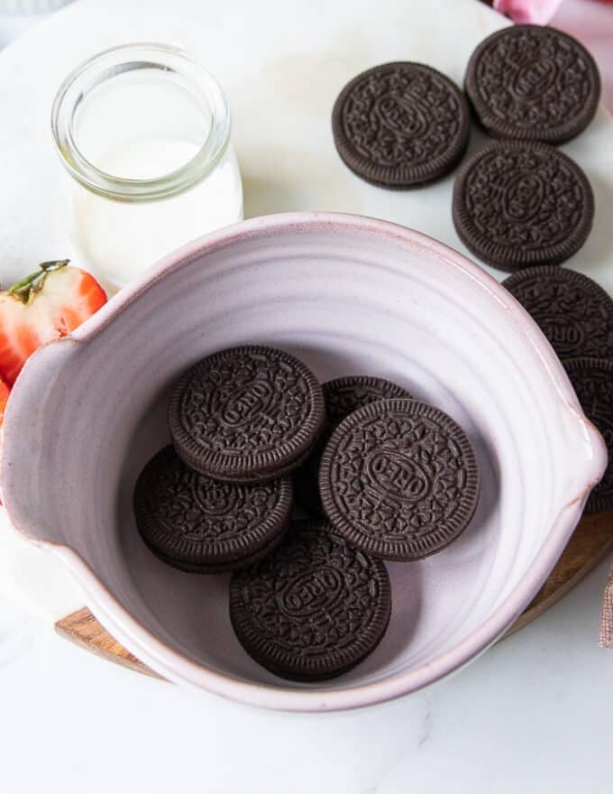 The oreos added to the bottom of a bowl to make oreo mug cake