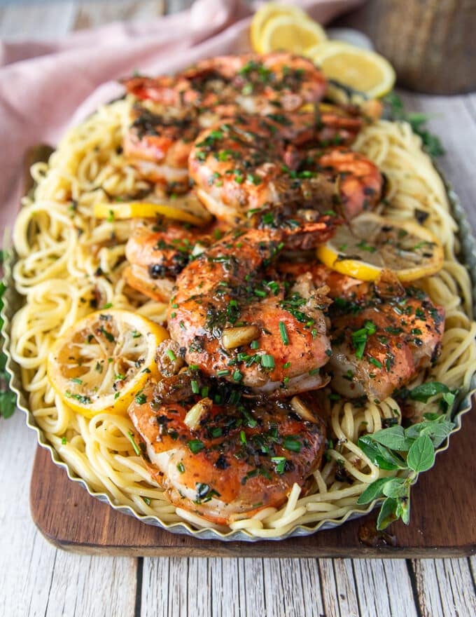 close up of shrimp scampi served over pasta